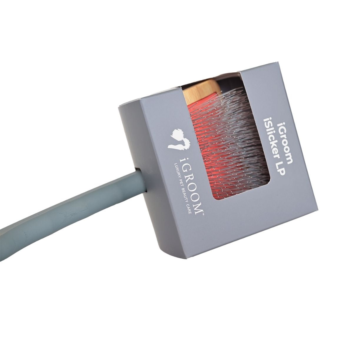 A close-up of a grey rectangular box containing a grooming brush, with a grey handle extending to the left. The brush has red and silver bristles visible through a clear window on the box.
